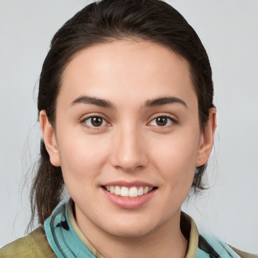 Joyful white young-adult female with medium  brown hair and brown eyes