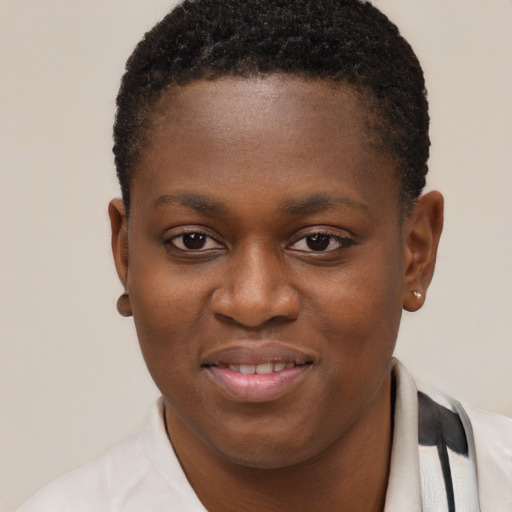 Joyful black young-adult female with short  brown hair and brown eyes