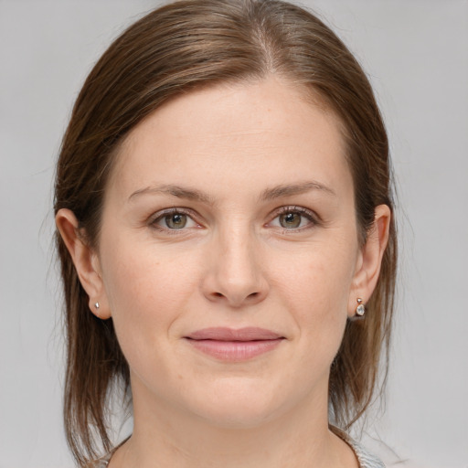 Joyful white young-adult female with medium  brown hair and grey eyes