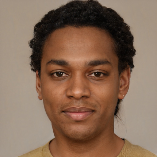 Joyful black young-adult male with short  black hair and brown eyes