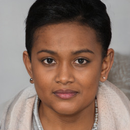 Joyful black young-adult female with short  brown hair and brown eyes
