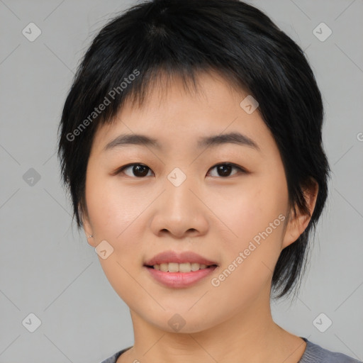 Joyful asian young-adult female with medium  black hair and brown eyes