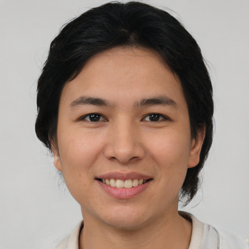 Joyful asian young-adult female with medium  brown hair and brown eyes