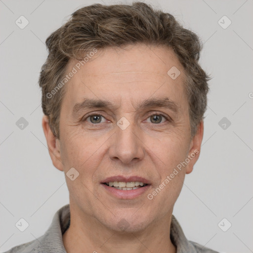 Joyful white adult male with short  brown hair and grey eyes