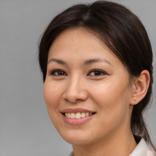 Joyful asian young-adult female with medium  brown hair and brown eyes