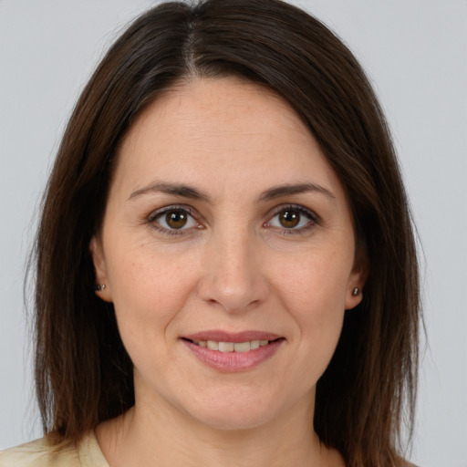 Joyful white young-adult female with medium  brown hair and brown eyes