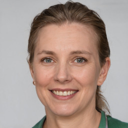 Joyful white adult female with medium  brown hair and grey eyes