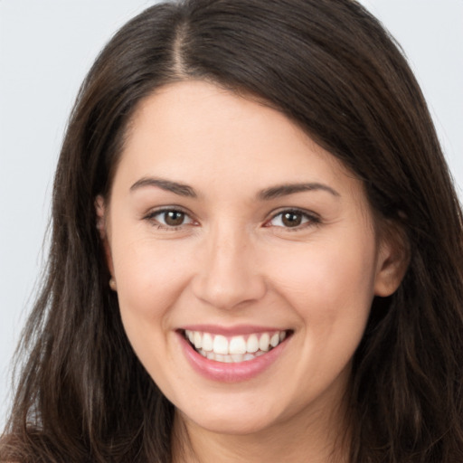 Joyful white young-adult female with long  brown hair and brown eyes