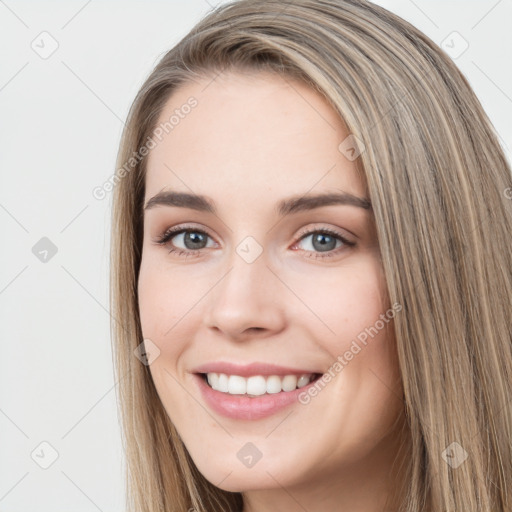 Joyful white young-adult female with long  brown hair and grey eyes