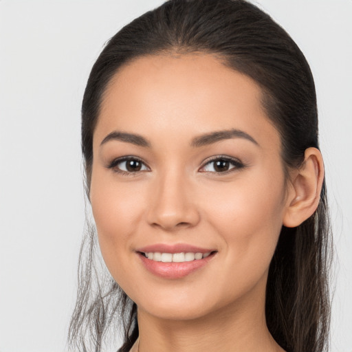 Joyful white young-adult female with long  brown hair and brown eyes