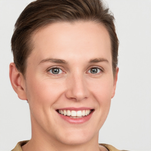 Joyful white young-adult female with short  brown hair and grey eyes