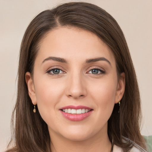 Joyful white young-adult female with long  brown hair and grey eyes