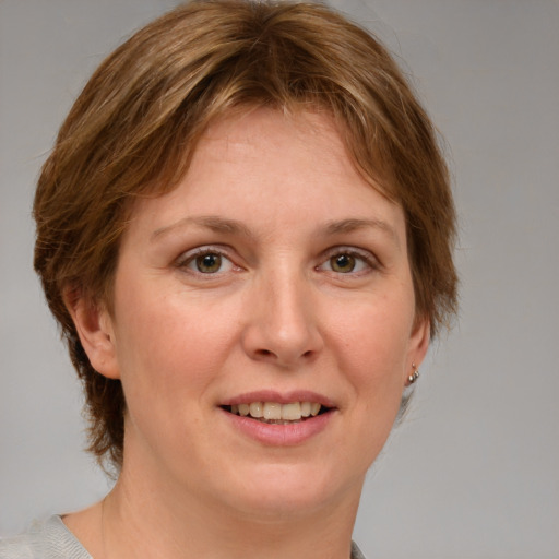 Joyful white adult female with medium  brown hair and grey eyes