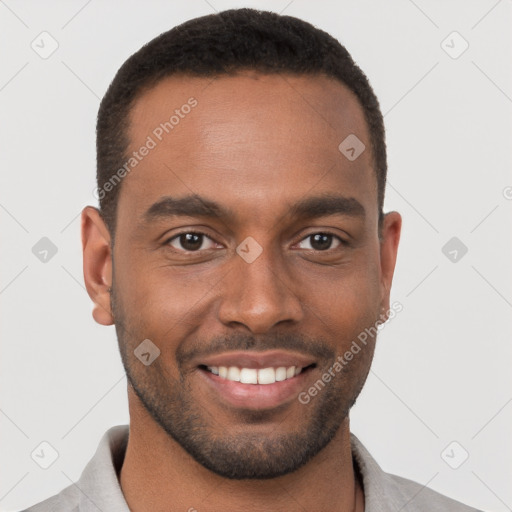 Joyful black young-adult male with short  brown hair and brown eyes