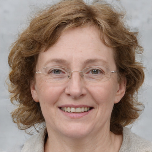 Joyful white adult female with medium  brown hair and blue eyes