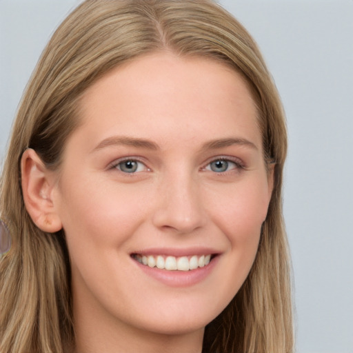 Joyful white young-adult female with long  brown hair and grey eyes