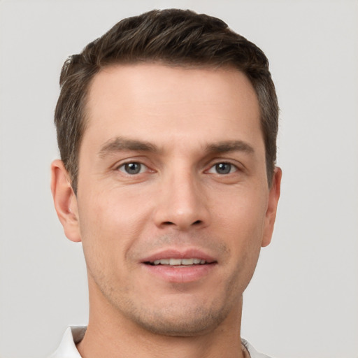 Joyful white young-adult male with short  brown hair and brown eyes