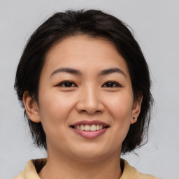 Joyful asian young-adult female with medium  brown hair and brown eyes