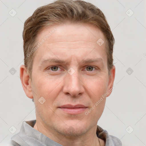 Joyful white adult male with short  brown hair and grey eyes