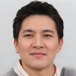 Joyful asian young-adult male with short  brown hair and brown eyes