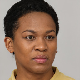 Joyful black adult female with short  brown hair and brown eyes