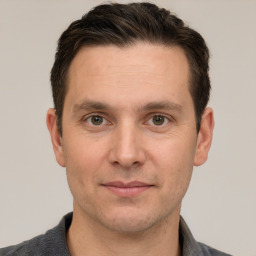 Joyful white adult male with short  brown hair and grey eyes