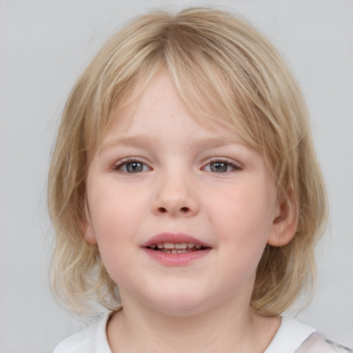 Joyful white child female with medium  brown hair and blue eyes