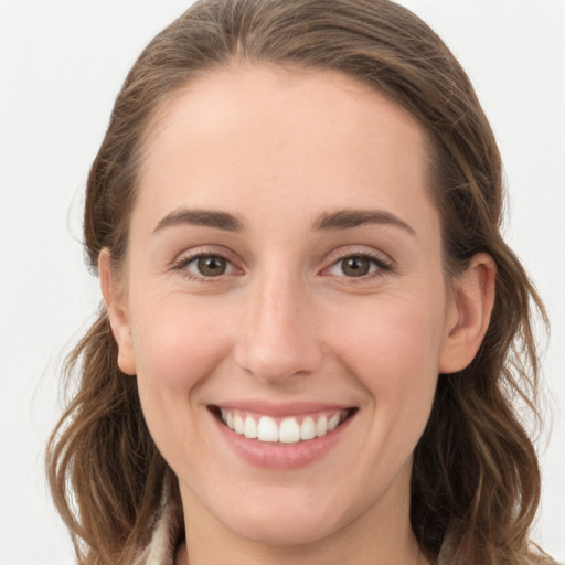 Joyful white young-adult female with long  brown hair and grey eyes