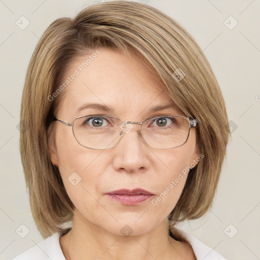 Joyful white adult female with medium  brown hair and blue eyes