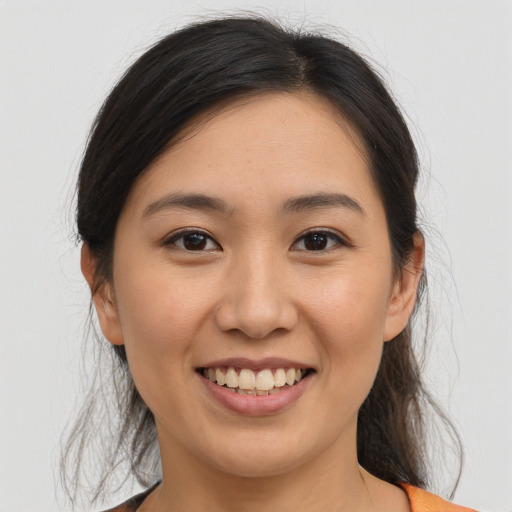 Joyful white young-adult female with medium  brown hair and brown eyes