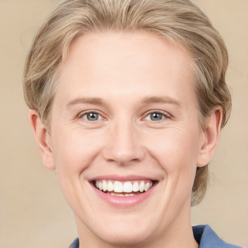 Joyful white young-adult female with medium  blond hair and blue eyes