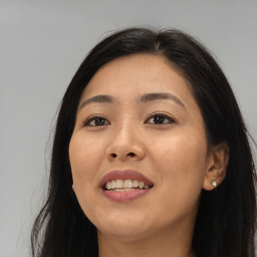 Joyful asian young-adult female with long  brown hair and brown eyes