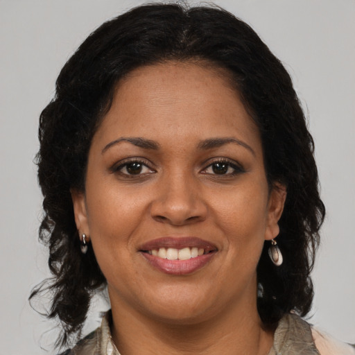 Joyful black adult female with medium  brown hair and brown eyes