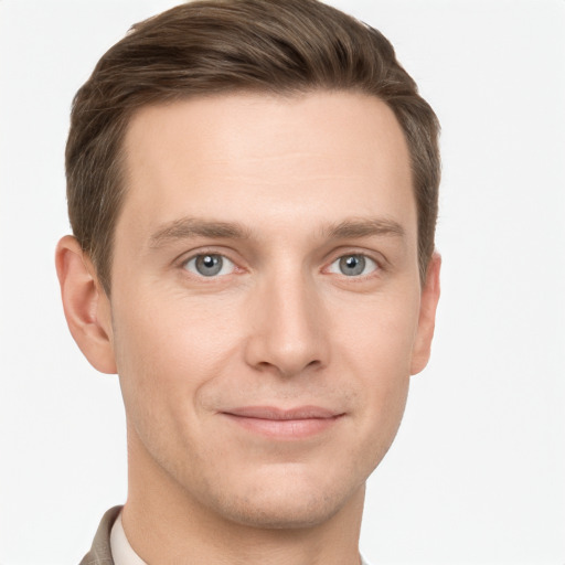 Joyful white young-adult male with short  brown hair and grey eyes