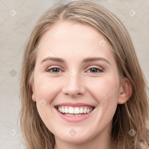 Joyful white young-adult female with long  brown hair and grey eyes