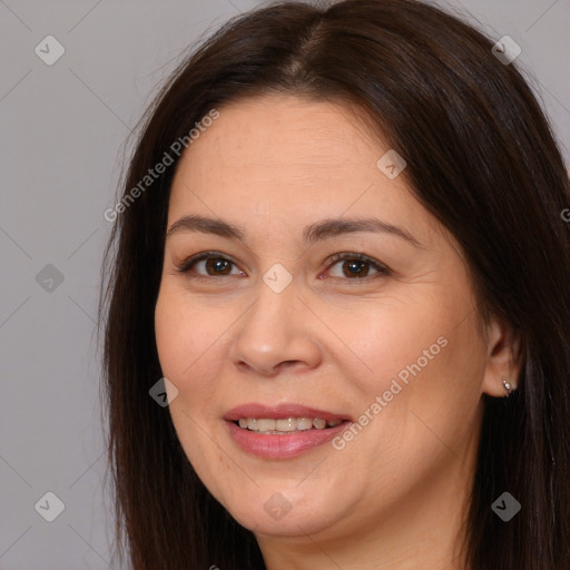 Joyful white adult female with long  brown hair and brown eyes