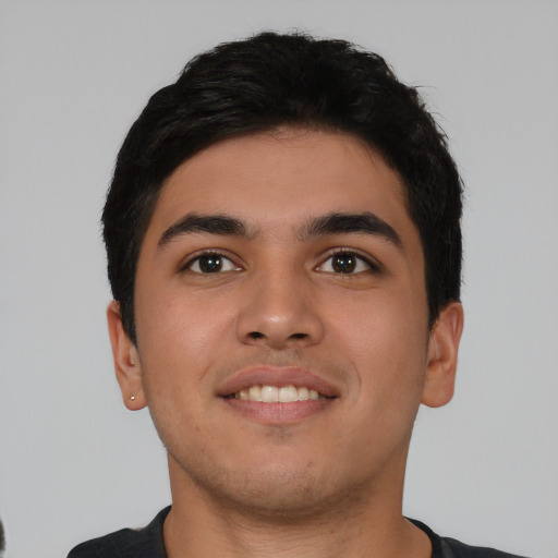 Joyful asian young-adult male with short  black hair and brown eyes