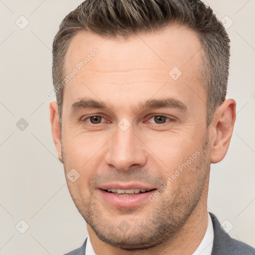 Joyful white adult male with short  brown hair and brown eyes