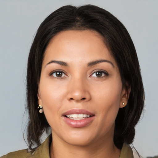 Joyful latino young-adult female with medium  brown hair and brown eyes