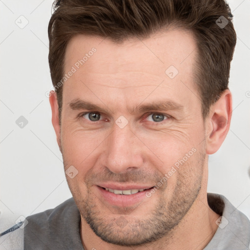 Joyful white adult male with short  brown hair and grey eyes