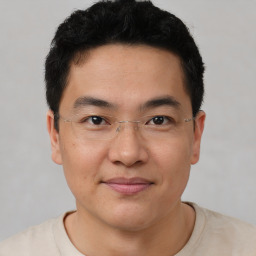 Joyful asian young-adult male with short  black hair and brown eyes