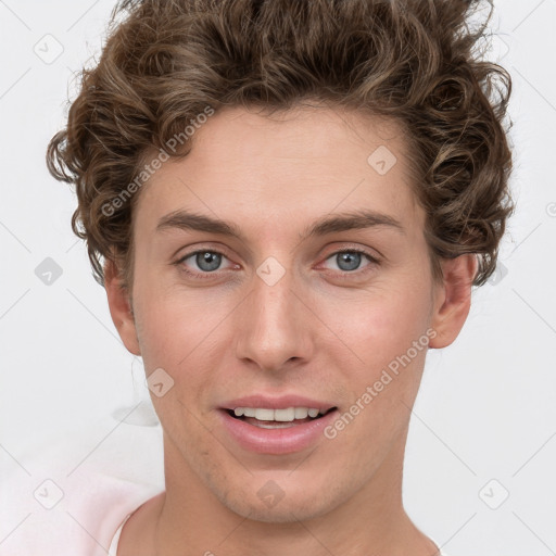 Joyful white young-adult male with short  brown hair and green eyes