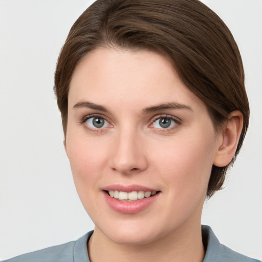 Joyful white young-adult female with short  brown hair and grey eyes