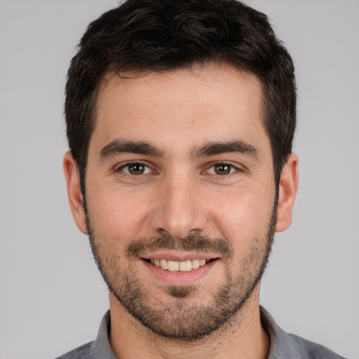 Joyful white young-adult male with short  brown hair and brown eyes