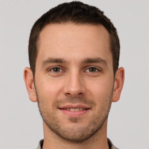 Joyful white young-adult male with short  brown hair and brown eyes