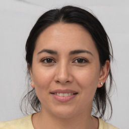 Joyful white young-adult female with medium  brown hair and brown eyes