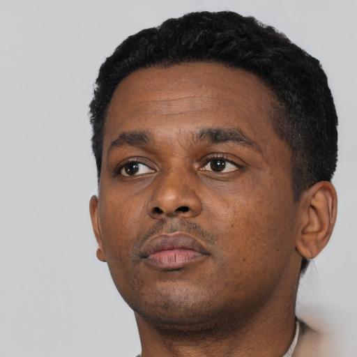 Neutral black young-adult male with short  black hair and brown eyes
