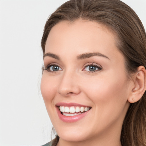 Joyful white young-adult female with long  brown hair and grey eyes