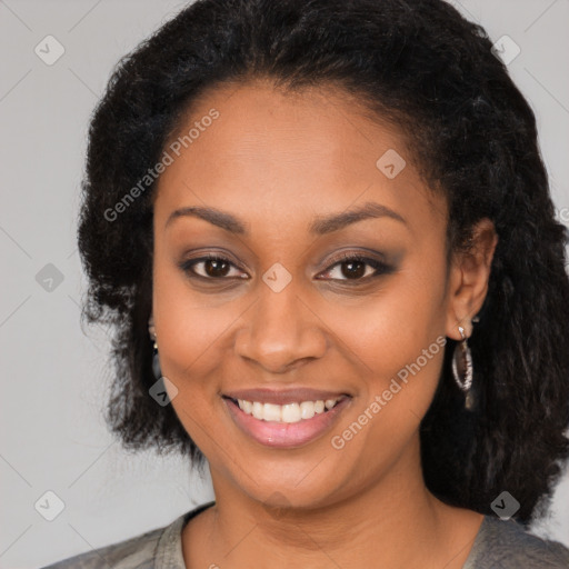 Joyful black young-adult female with long  black hair and brown eyes