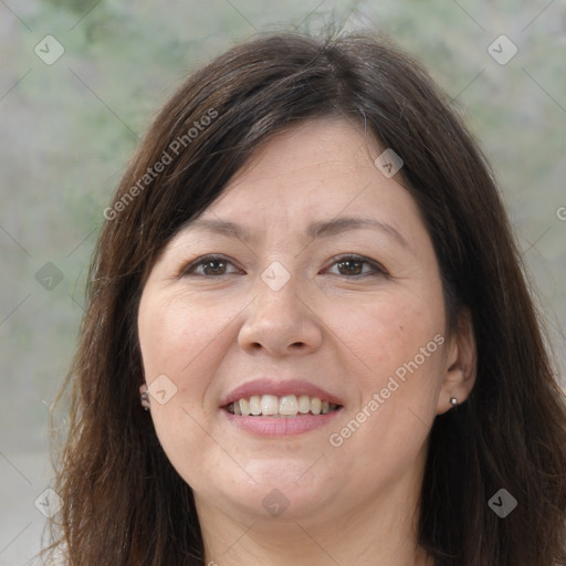 Joyful white adult female with long  brown hair and brown eyes